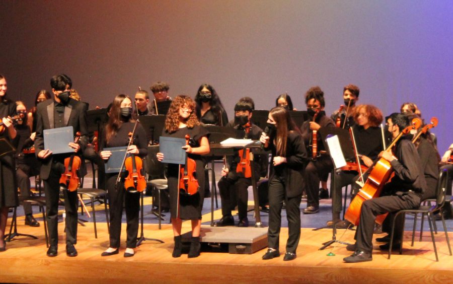 Orchestra Director, Ms. Lisa Coyne, ends the concert with members
bowing for the audience.