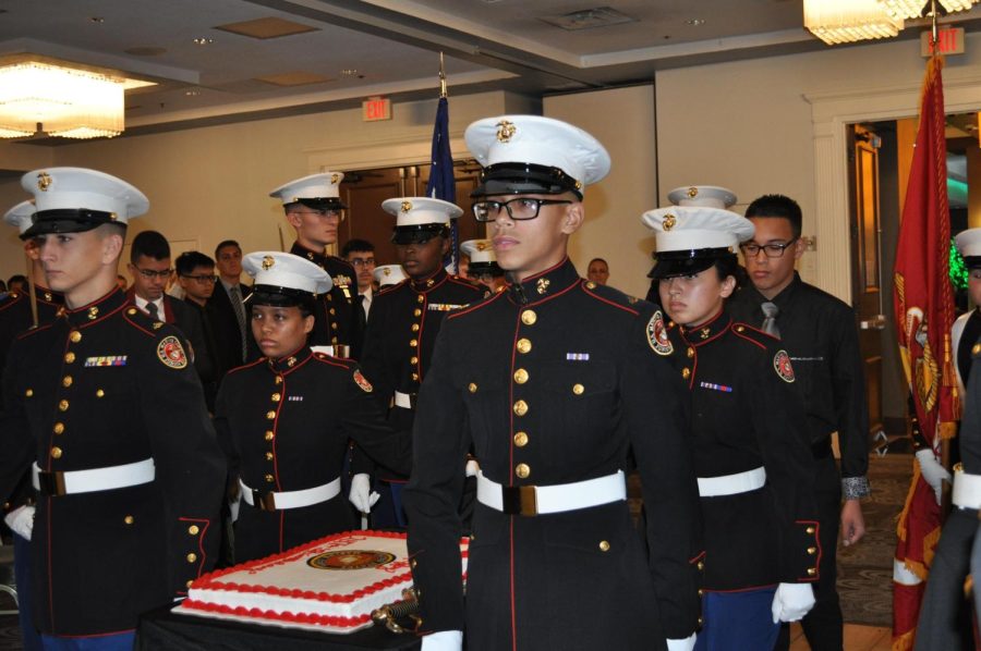 UHS+JROTC+members+stand+around+a+birthday+cake+commemorating+the+United+States+Marine+Corps+247th+birthday.