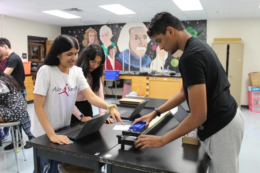 Students in Ms. Sue Hwang’s Physics class participate in a lab that explores the concept of velocity. 
