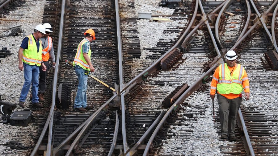 Workers service the tracks at the Metra/BNSF railroad yard outside of downtown on September 13, 2022 in Chicago, Illinois. 
