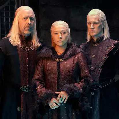 House of the Dragon cast Viserys, Rhaenyra, and Daemon Targaryen pictured standing next to each other, played by Paddy Considine, Emma D’Arcy, and Matt Smith.
