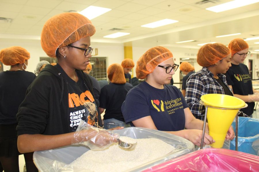 Students in Helping the Homeless work together to create jambalaya bags.