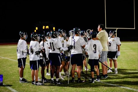 The Lacrosse team huddles before their game against Lake Wales.
