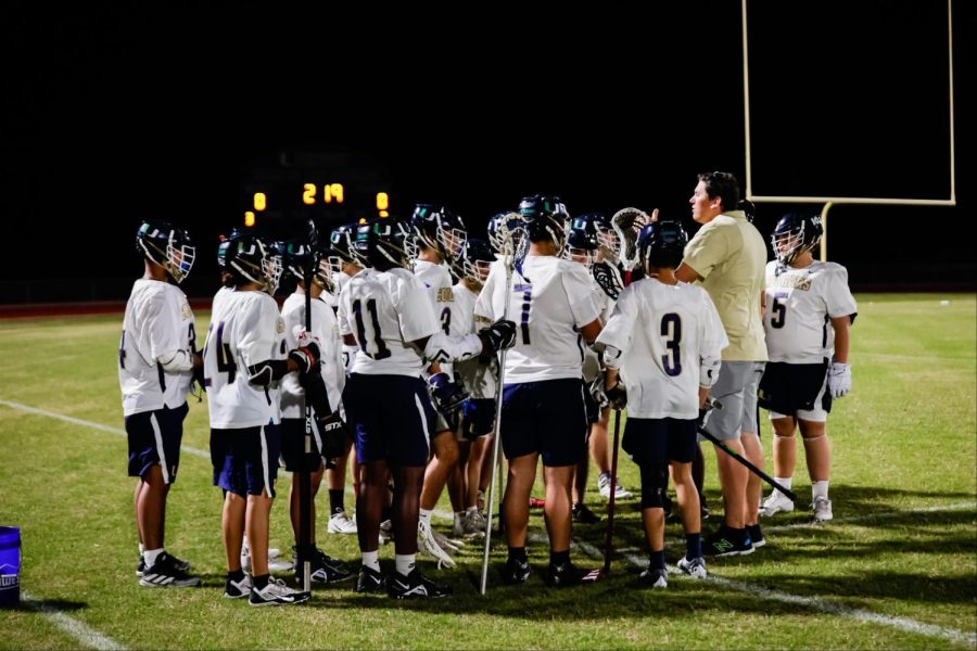 The+Lacrosse+team+huddles+before+their+game+against+Lake+Wales.