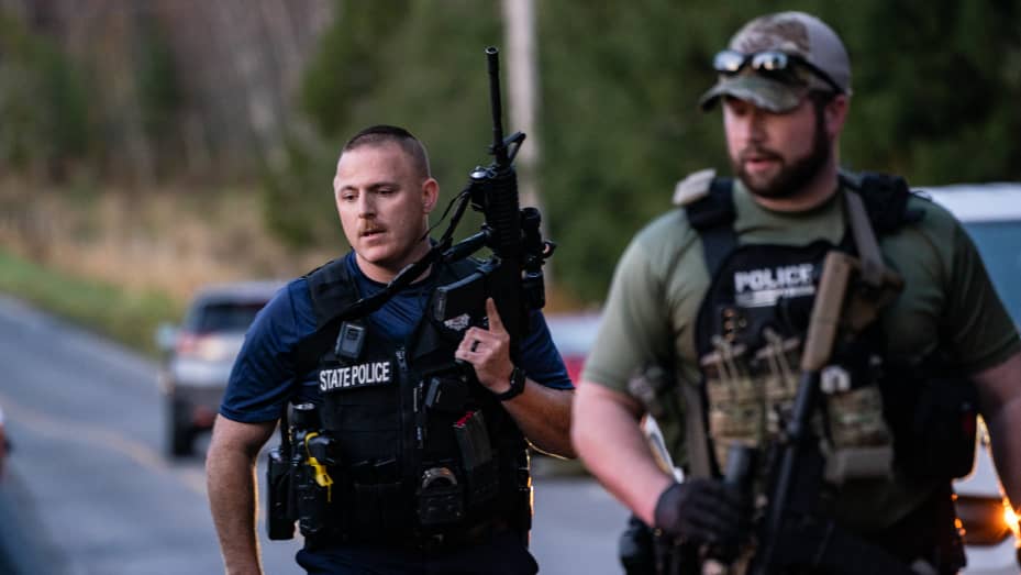 Police secure the area where a gunman opened fire, killing 18 people. 