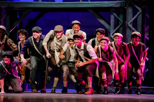 Students perform a dance scene from Newsies.