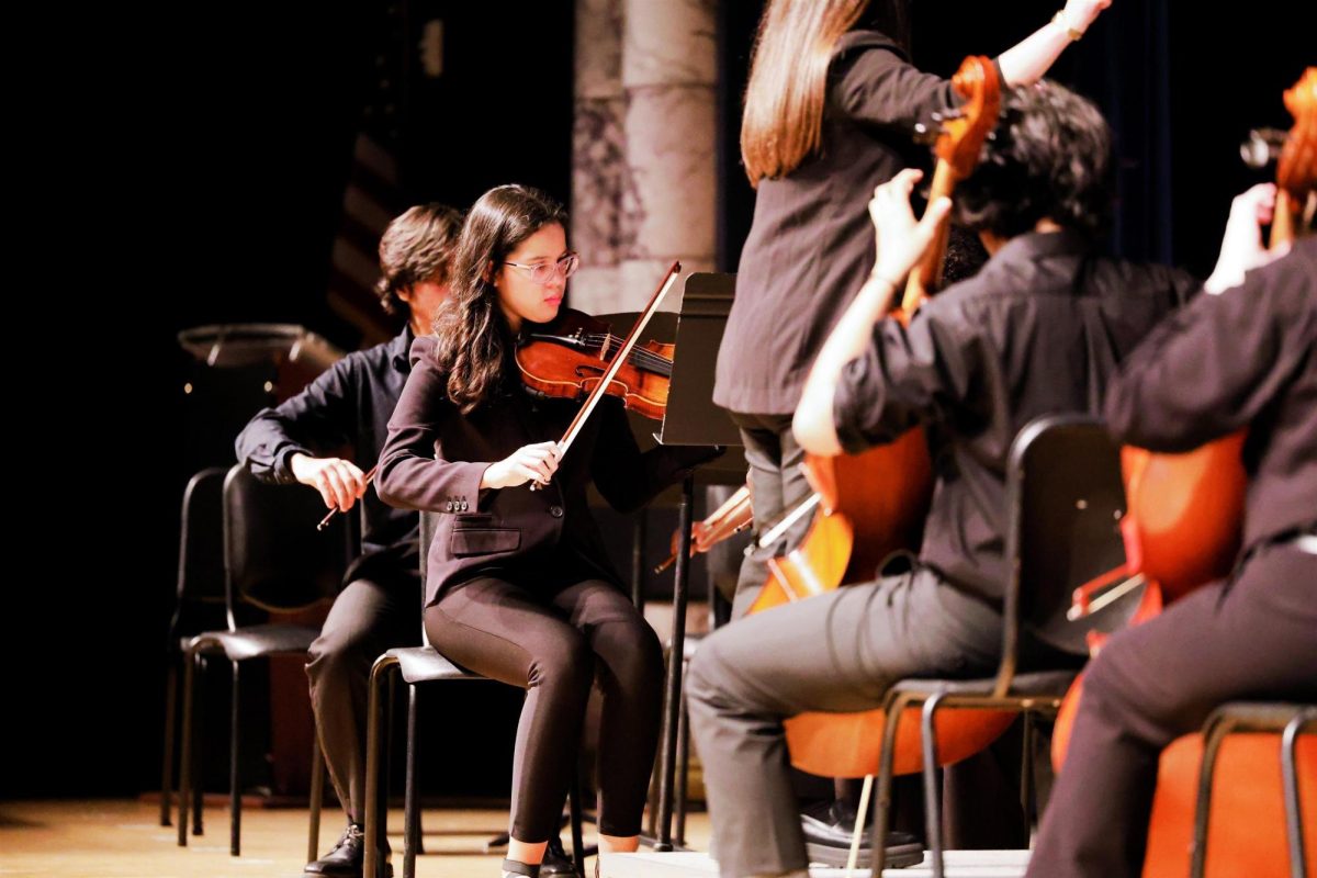 Freshman Olivia Caurtas pictured playing violin at the Fall Concert.