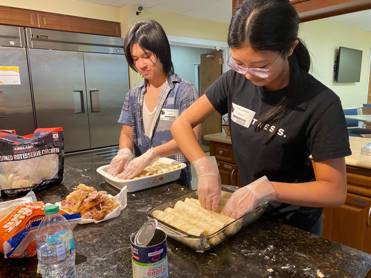 Beta Club members Lara Jimenez and Benjamin Vo pictured making dinner for the Ronald McDonald House.