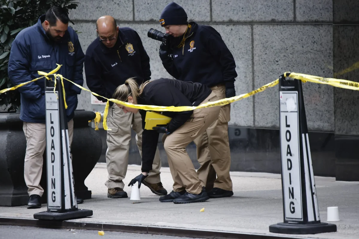 Members of the NYPD investigating the crime scene outside the Hilton Hotel in midtown Manhattan.