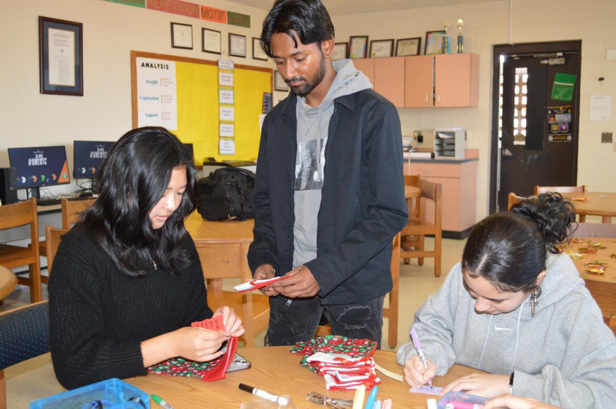 Beta Club members Lara Jimenez and Ved Patel make labels for stockings for families staying at the 
Ronald McDonald House.