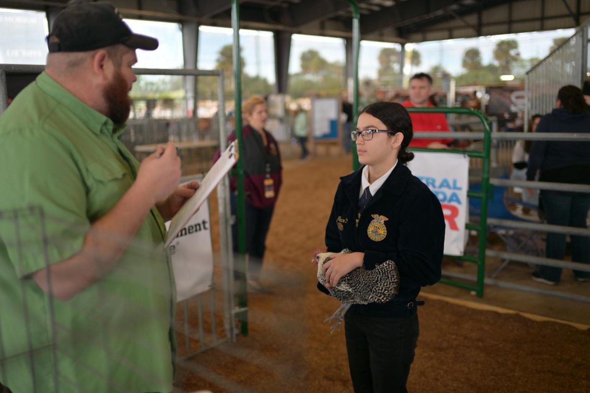 Junior Allison Feliciano Pena answers questions regarding her chicken while at the Central Florida Fair