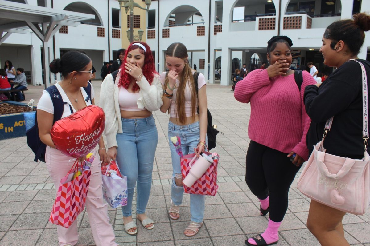 Friends share Valentine's Day gifts in the courtyard.