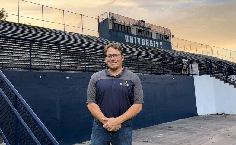 Coach Carrington pictured in front of the UHS bleachers.