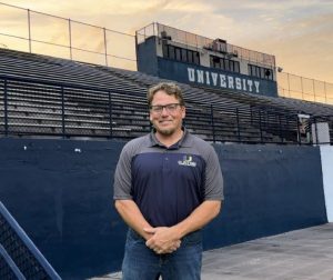 Coach Carrington pictured in front of the UHS bleachers.