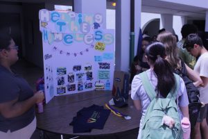 Helping the Homeless club officers featured presenting their board during lunch.