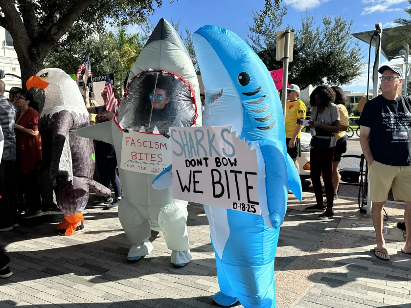 Floridians dressed in inflatable costumes while protesting “No Kings” in downtown Orlando.
